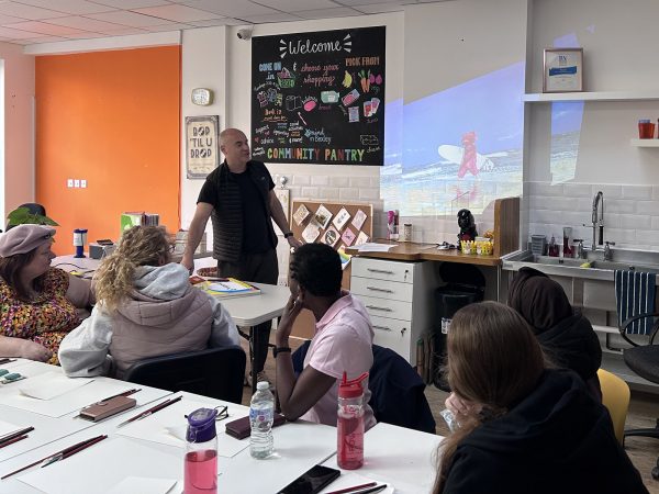 Paul Robinson stood giving a talk to a group of seated women from the Menopause Group in Bexleyheath