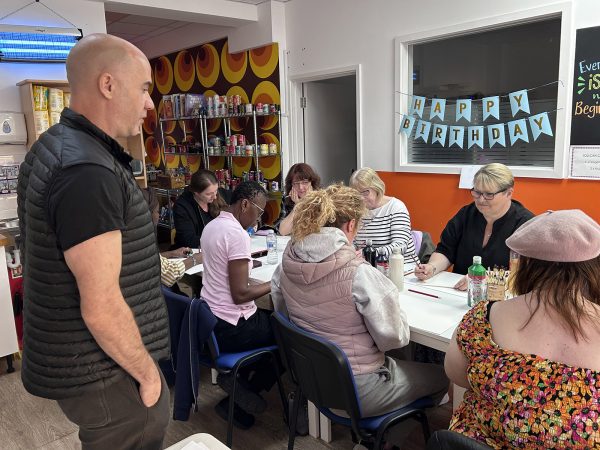 Paul Robinson stood giving a talk to a group of seated women from the Menopause Group in Bexleyheath