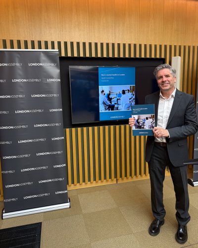 Dr David Palmer stood holding the Men