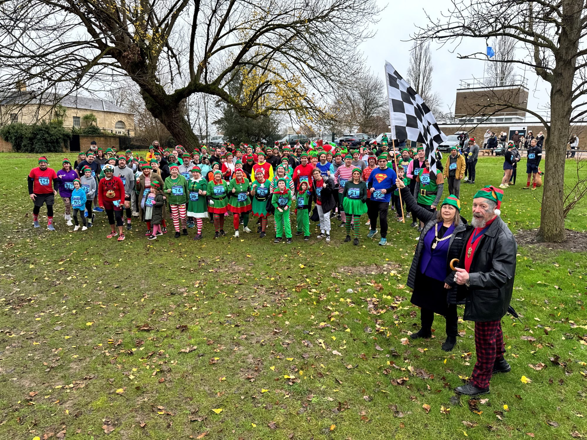 The Mayor of Bexley Cllr Christine Catterall waves the start flag in an overcast Danson Park