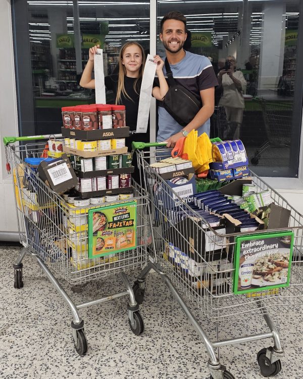 Louis Webb with his daughter as they shop for donations for the Bexley Community Pantry