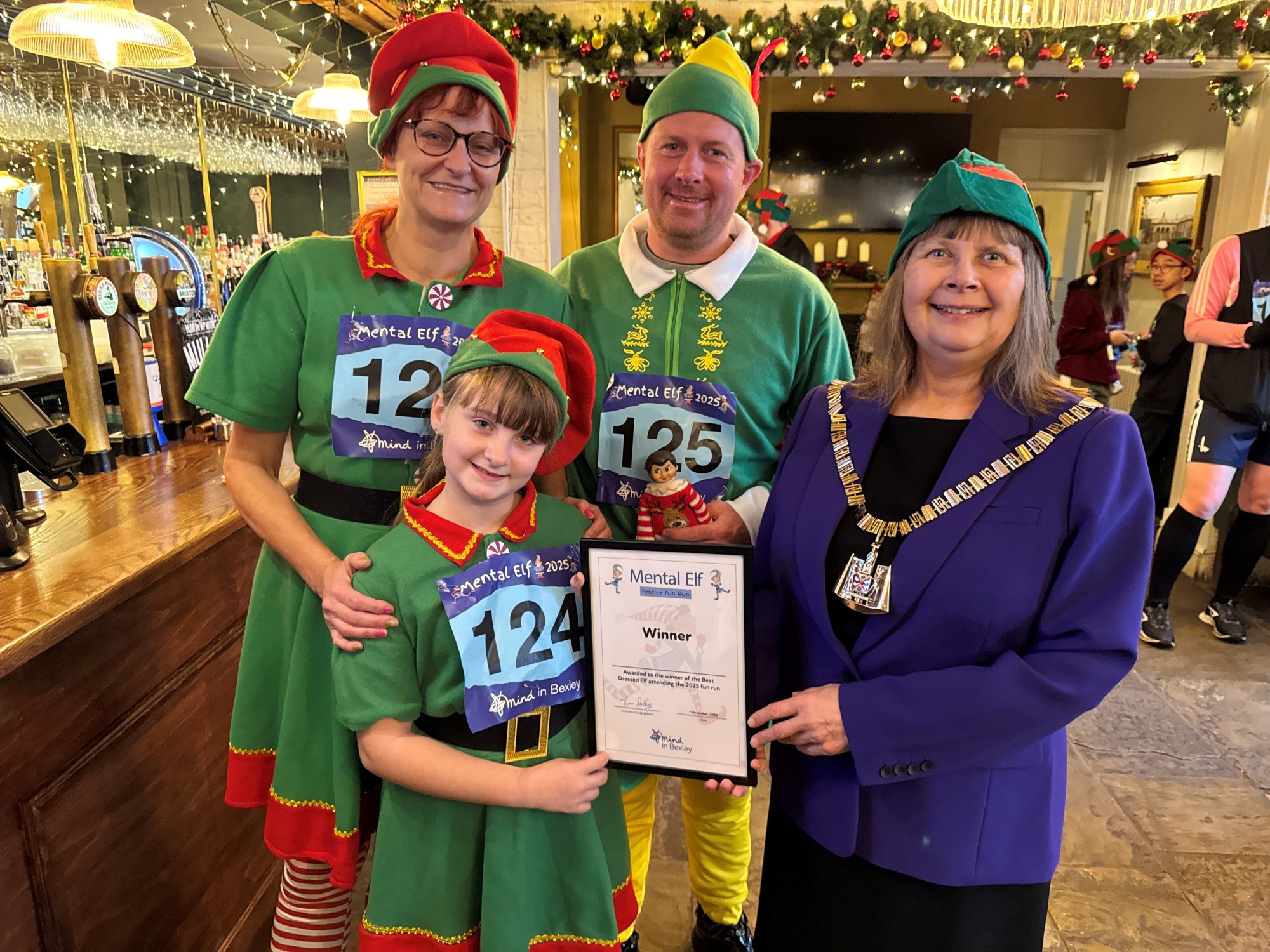 Penny Cole, aged seven, with the best dressed child elf award. She's stood with two adult elves and the Mayor of Bexley, Cllr Christine Catterall