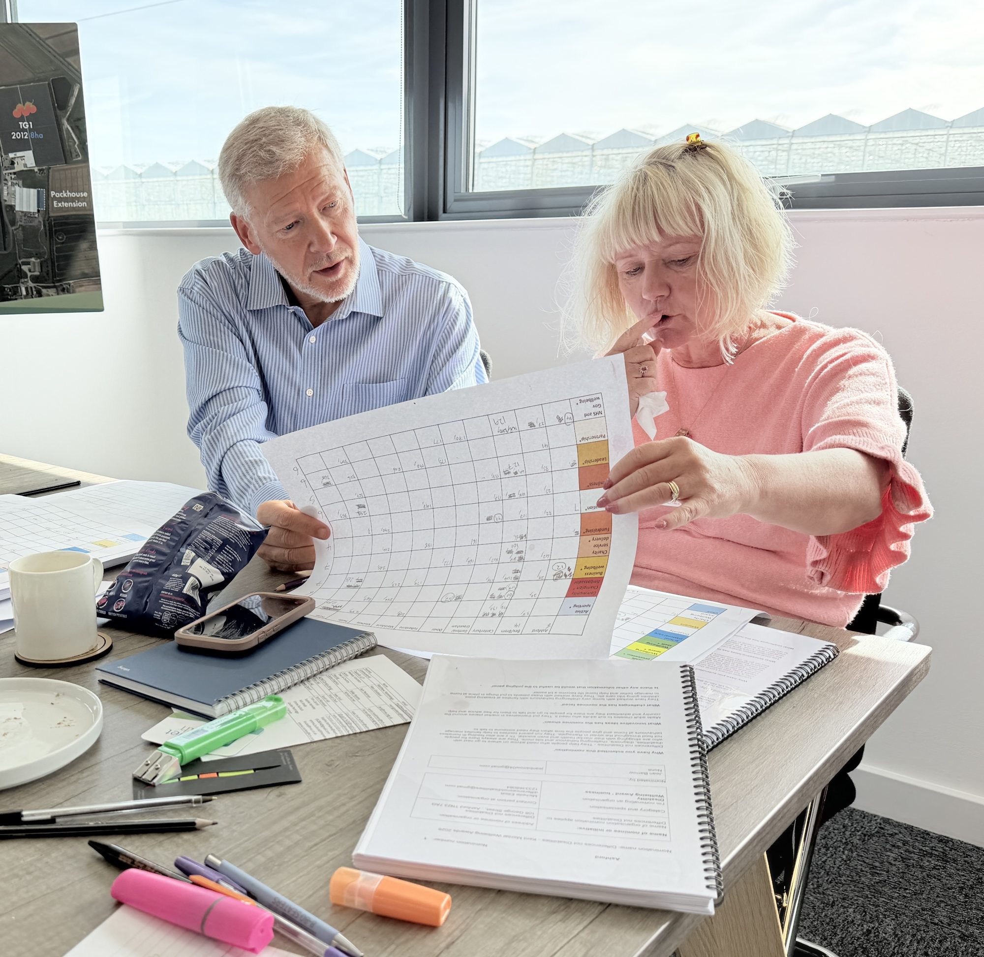 Two people look at score sheet