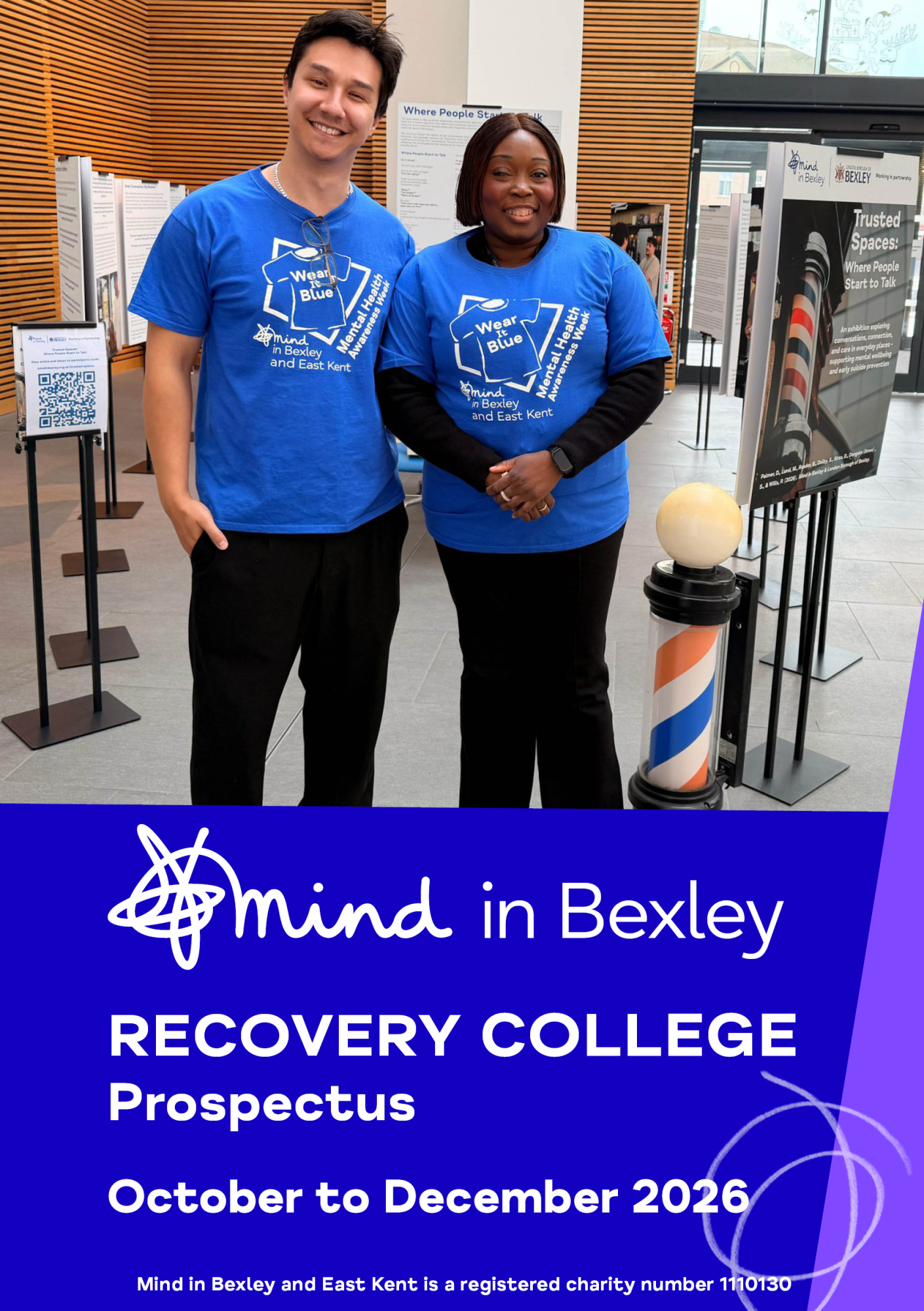 MiB – Oct-Dec 26 Two people wearing blue Mind in Bexley and East Kent Mental Health Awareness Week T-shirts stand beside information displays. Below, text reads: “Mind in Bexley Recovery College Prospectus – October to December 2026.”