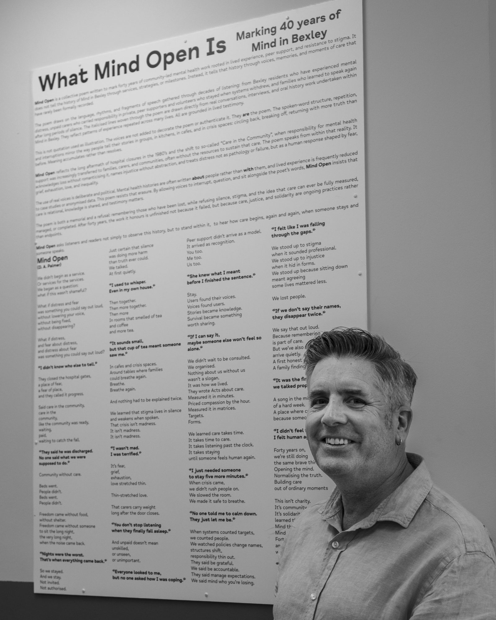 Dr David Palmer, CEO of Mind in Bexley and newly elected Chair of Mind in London is photographed in front of an information board celebrating the 40th anniversary of Mind in Bexley
